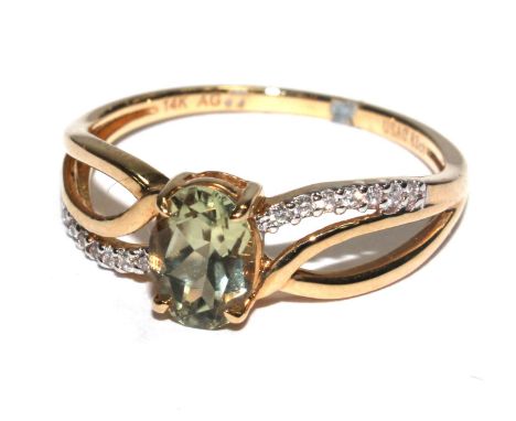 A peridot ring set in 14 carat gold 