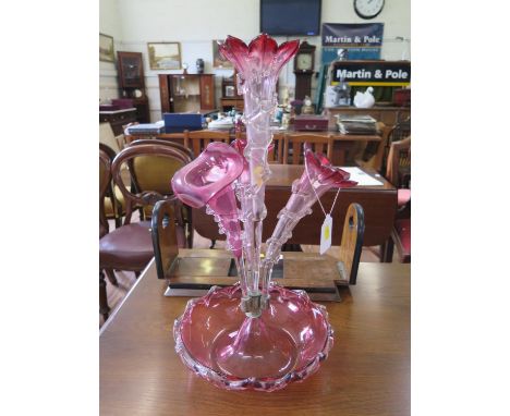 A Victorian red glass epergne, with four trumpet vases on a circular dish, 46 cm high 