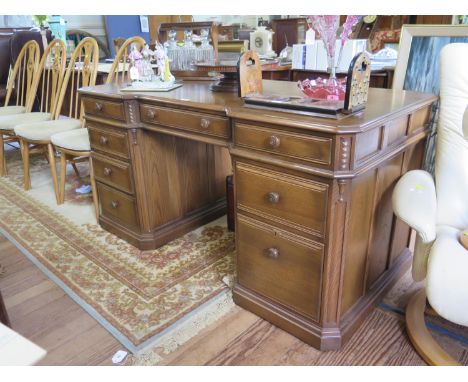 A limited edition Ercol elm 'Roxburghe Desk', number 10 of 250, with brass plaque and Ercol button to the centre drawer, expl