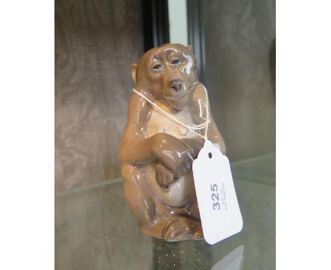 A Royal Copenhagen figure of a seated monkey, numbered 1454/1444, 13 cm high 