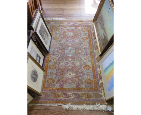 A Caucasian style rug, with geometric flowerheads on a light blue field, within a geometric multiple border, 184 x 130 cm 