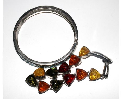 A bracelet of eleven polished amber pieces together with a white metal and enamel bangle 