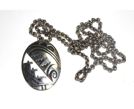 An oval silver and black enamel pendant on silver chain signed DA 