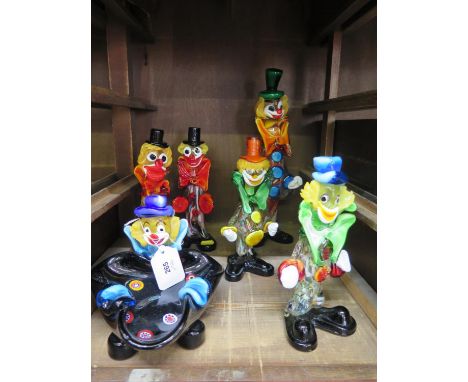 A collection of Murano glass multi coloured clown models comprising four small figures one large and a tray 