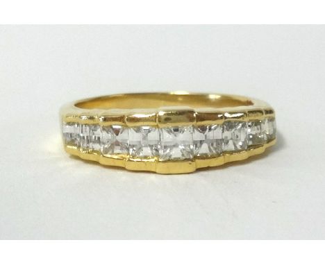 An 18ct Millennium cut diamond ring, set with 9 diamonds, finger size M.
