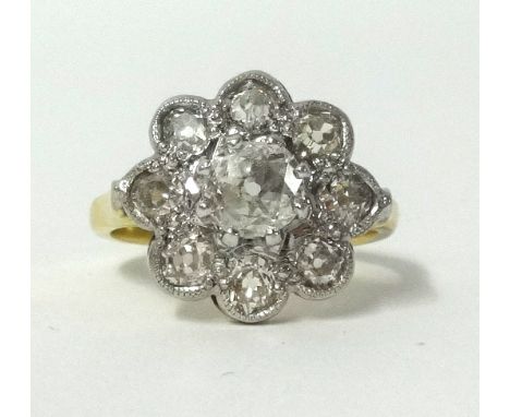 An 18ct diamond cluster ring, finger size M.