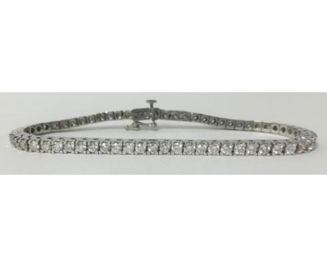 A fine 18ct white gold diamond line bracelet, approx 4.50cts of round cut diamonds.