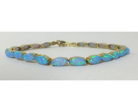 A 14ct opal line bracelet set in yellow gold.