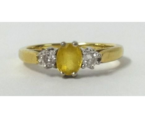 An 18ct yellow sapphire and diamond 3 stone ring.