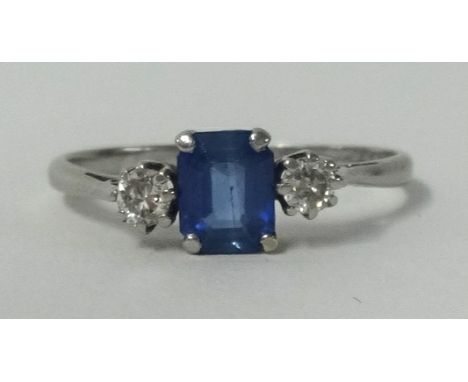 A platinum sapphire and diamond 3 stone ring.