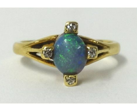 A 9ct opal and diamond 4 stone ring, finger size J.