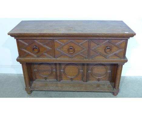 An oak Arts and Crafts sideboard base with three drawers above three recessed cupboard doors and turned supports - Height 88c