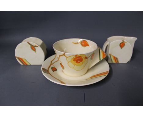A Clarice Cliff conical cup and saucer, milk jug and sugar - marked Bizarre by Clarice Cliff Wilkinson Ltd to base, also mark