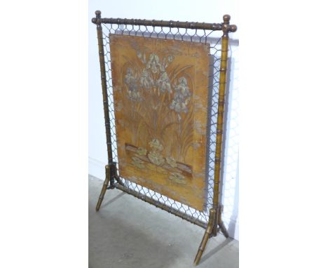 A German Jugendstill tooled leather fire screen by Georg Hulbe of Hamburg, incised and embossed Irises and Lily pads on a fau