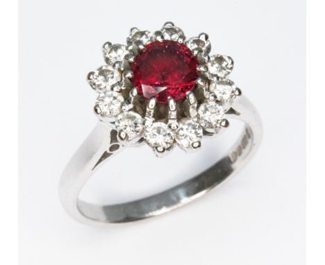 A diamond and ruby cluster ring, cluster diam. approx. 12.5mm, hallmarked 18ct white gold, Birmingham 1976, gross wt. 4.6g, s