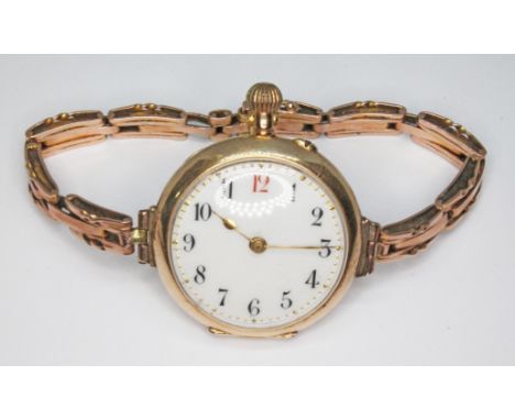 A ladies enamel back wristwatch marked '14c', strap marked '9c', gross wt. 29.5g.  Condition - not currently running.