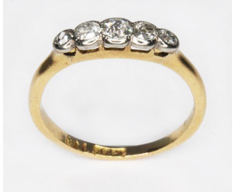 A five stone diamond ring, the bezel set stones weighing approx. 0.04, 0.06, 0.10, 0.05 &amp; 0.03 carats, band marked 'GFF' 