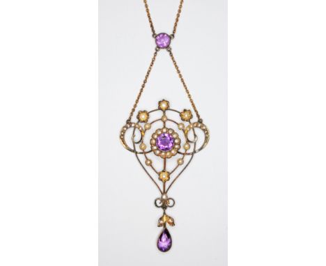 An early 20th century amethyst and seed pearl pendant necklace, pendant marked '9ct', the chain '9', pendant length 73mm, cha