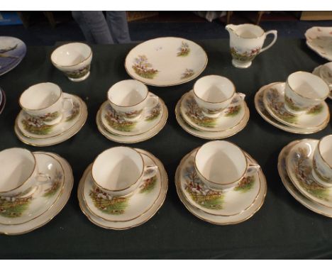 A Part Tea Set Comprising Eight Trios, Cake Plate, Sugar and Milk Jug with Hunting Decoration. 