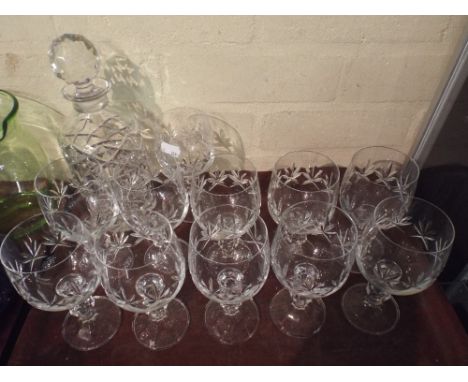 A Cut Glass Decanter and Set of Eleven Wine Glasses.