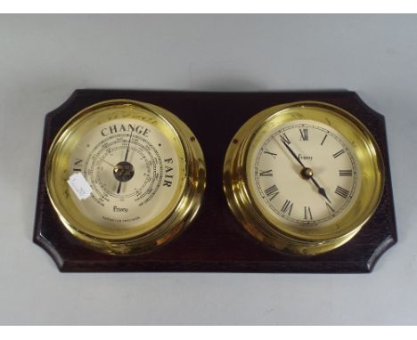 A Priory Ships Clock/Barometer on Wooden Plinth.