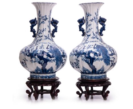 Pair of blue and white porcelain vases gourd shaped decorated with plum blossom trees and  peacocks. Marked with KangXi honor