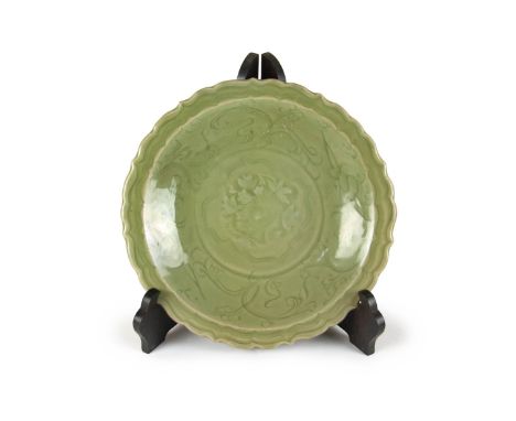 Ming dynasty Thickly molded with a raised edge to the  bracket-lobed rim, the lobed sides forming the  shallow well, peony bl