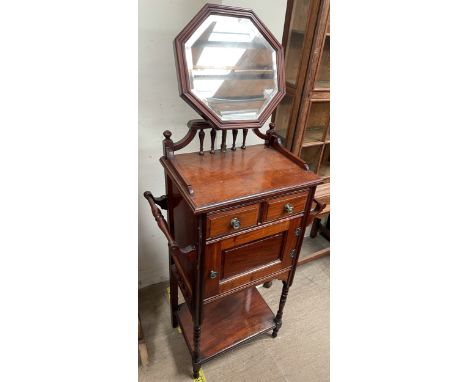 An Edwardian mahogany washstand, with an adjustable octagonal mirror, the top with a three quarter gallery, towel rails, two 