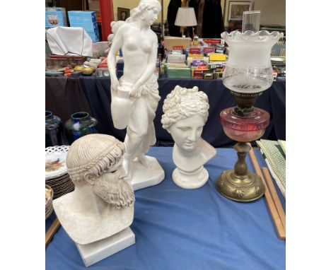 An oil lamp, with a graded ruby glass reservoir together plaster busts and figures