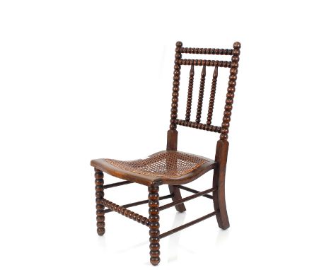 A 19th Century bobbin framed nursing chair,&nbsp;with cane panel seat