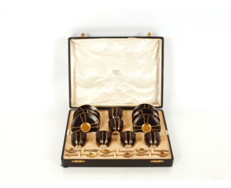 Two cased sets of six each Royal Worcester black and gilt coffee cups and saucers;&nbsp;together with six each silver gilt sp