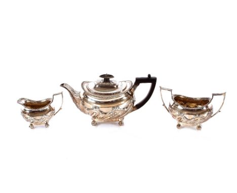 A late Victorian&nbsp;silver three piece tea set,&nbsp;having gadrooned borders and raised foliate decoration, the teapot wit