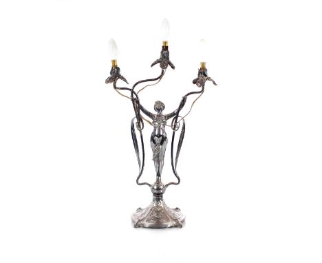 An Art Nouveau three light candelabra,&nbsp;in the form of a maiden with outstretched arms on mask and foliate scroll spread 