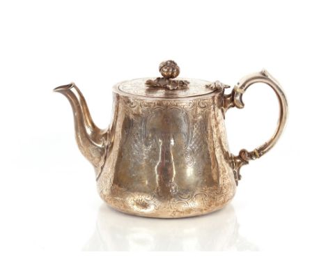 A Victorian silver teapot,&nbsp;having all over foliate scroll decoration around a central cartouche with monogrammes,&nbsp;L