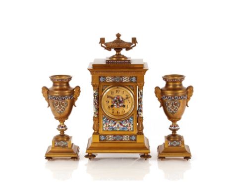 An Ormolu and enamel clock garniture,&nbsp;the clock surmounted by a urn finial, circular dial supporting an eight day moveme