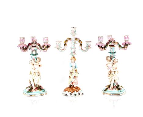 A pair of 19th Century German porcelain candelabra,&nbsp;having floral encrusted decoration and raised on columns supported b