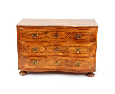 An 18th Century Italian walnut commode, of serpentine shape,&nbsp;the drawers with rosewood cross banding, brass handles and 