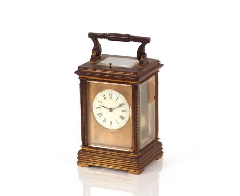 A brass cased striking carriage clock,&nbsp;with repeat movement having circular white enamel Roman numeral dial, 18cm high