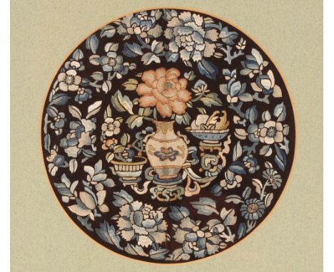 A circular&nbsp;Chinese embroidered panel,&nbsp;depicting vases of flowers in amongst a foliate border, 23.5cm dia.; and anot