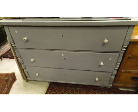 A continental painted pine three drawer commode with white china handles