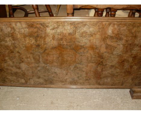 An early 20th Century walnut double bed frame, the whole stood upon bracket feet