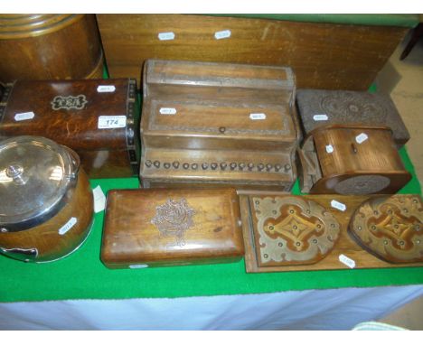 A selection of treen ware to include cigarette dispenser, desk tidy, tea caddy with domed top, oak biscuit barrel, etc