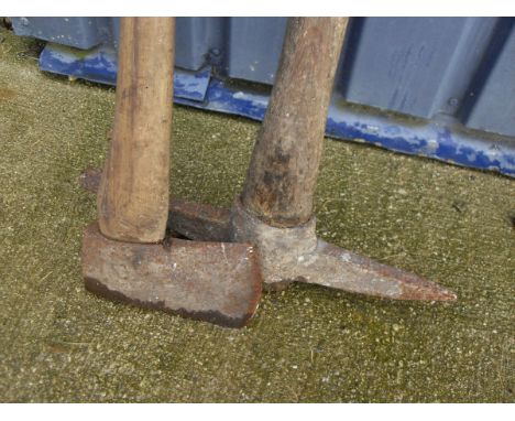 A wooden handled axe and a wooden handled pick axe