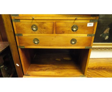 A pair of yew wood Campaign style bedside cabinets with brushing slide and leatherette inset top above two short and one long