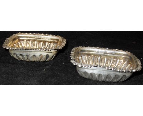 A pair of late Victorian silver embossed rectangular salts, together with a late Victorian mother or pearl cased silver blade