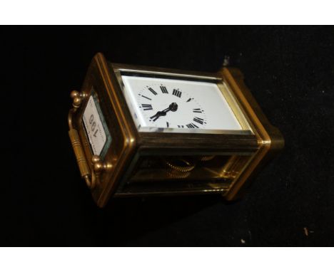 A brass carriage clock with Roman numerals to the enamelled dial, the top engraved "Okanagan Tennis Association Ladies Double