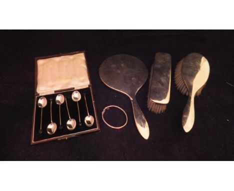 A cased set of six silver coffee bean spoons, together with a silver bangle and silver backed hand mirror with matching hairb