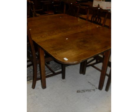 A 19th Century oak rectangular drop-leaf dining table with rounded corners, raised on square legs and a vintage oak office ch