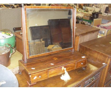 A Victorian mahogany and inlaid toilet mirror, the plain glass above a base of three drawers, raised on bracket feet