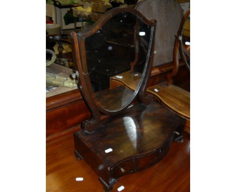 A Victorian mahogany and strung toilet mirror, the oval plate above a serpentine fronted base of three drawers, raised on bra
